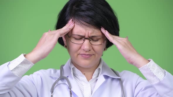 Stressed Woman Doctor with Short Hair Having Headache