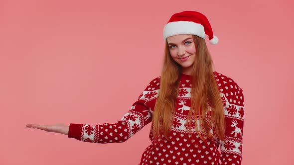 Woman Wears Red New Year Sweater Deer Showing Thumbs Up and Pointing at on Blank Advertisement Space