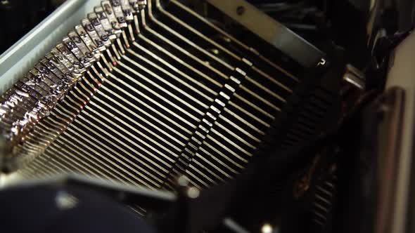 Mechanism of a retro typewriter. Old typewriter hammers. Slow motion. Close up.