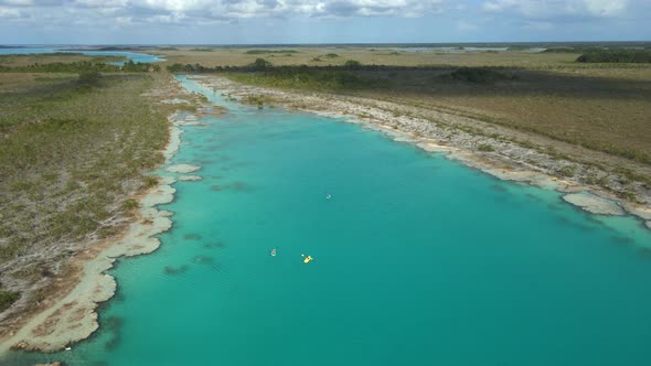 People Riding Kayak in Los Rapidos Lagoon in Bacalar Mexico