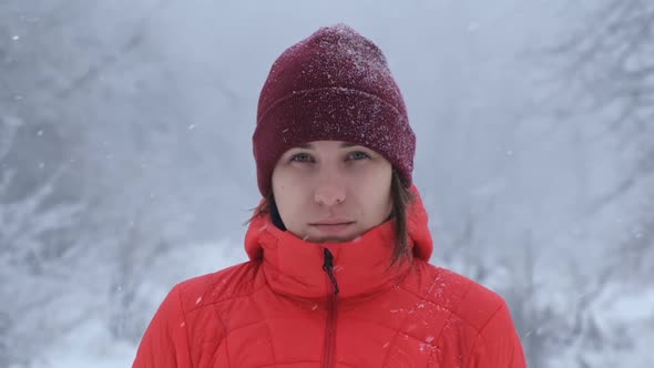 Young Woman Looking at the Camera in Winter Background