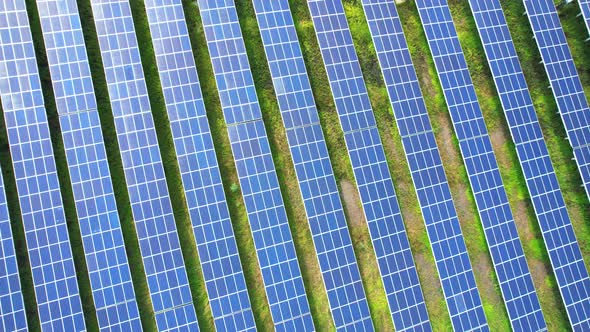 Drone fly over solar farm, renewable energy from solar.