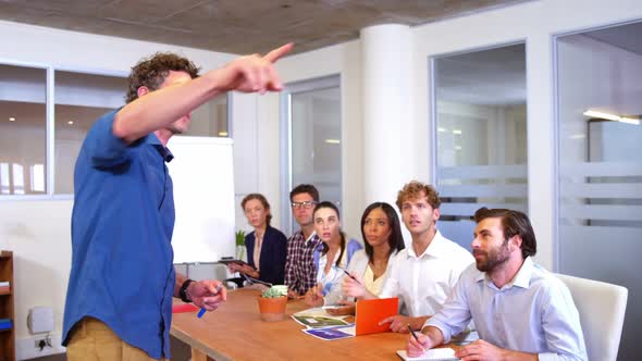 Male business executive interacting with coworker