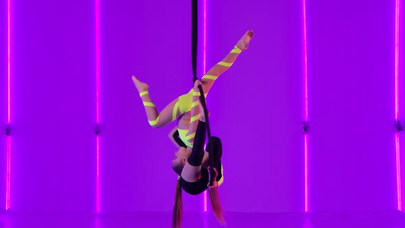 Two Young Girls Perform Acrobatic Elements on an Air Hoop