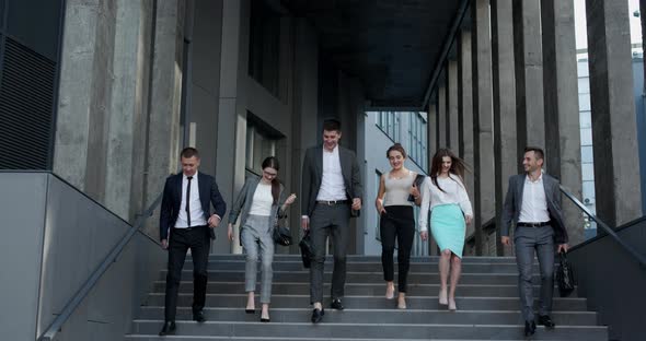 Confident Team Business Men and Women in Formal Suits Members Walking on Stairs