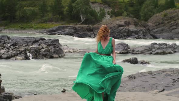 Young Woman in a Long Flowing Dress on the Background of the River and Mountains. Coloring Women