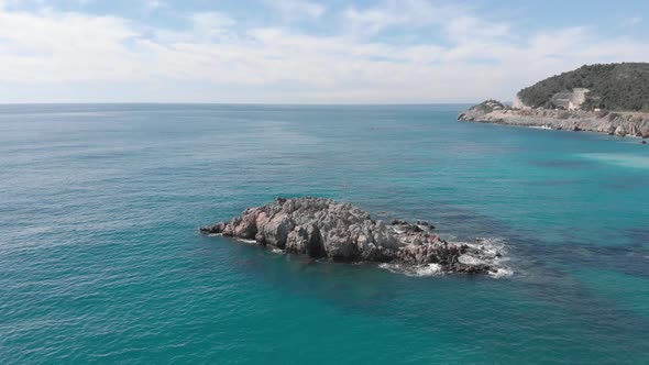 Waves crashing against empty stone rock cliff