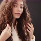 Studio portrait of young woman with long curly hair - VideoHive Item for Sale