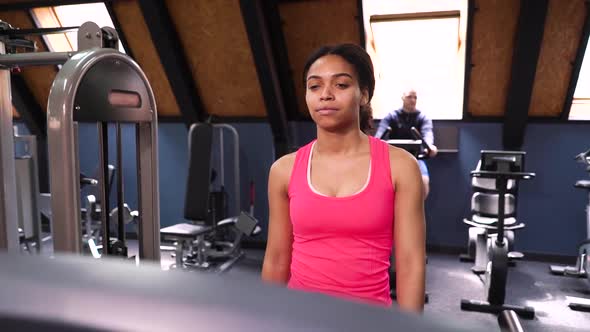 Black woman training on treadmill in gym