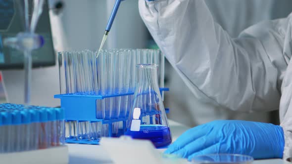 Close Up of Researcher Testing Liquid Sample Using Micropipette