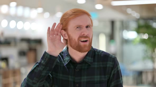 Portrait of Beard Redhead Man Listening Carefully 