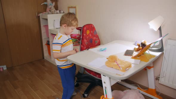 Boy At Desk At Home