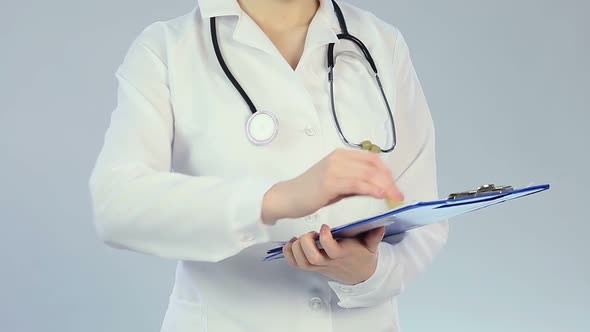 Female therapist checking patient's medical record, qualified clinical treatment