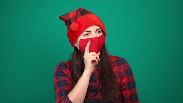 A Beautiful Woman Wearing Red Medical Mask and Christmas Hat Is Dreaming About Something