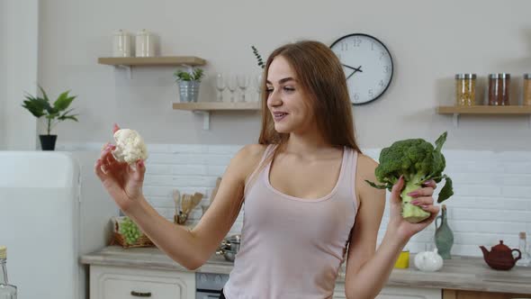 Girl Recommending Eating Raw Vegetable Food. Showing Broccoli and Cauliflower. Weight Loss, Diet