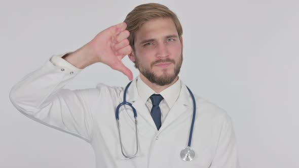 Thumbs Down By Young Doctor on White Background