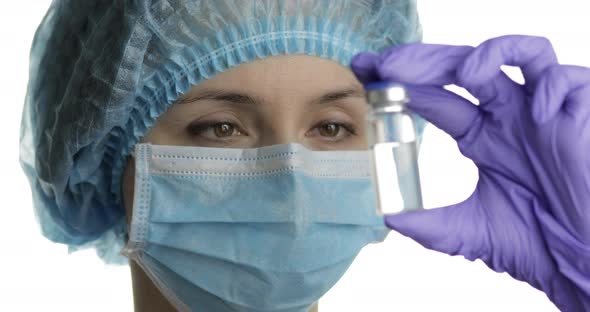 Female Scientist Holding Ampoule in Hand, New Medication Developing, Vaccination alt