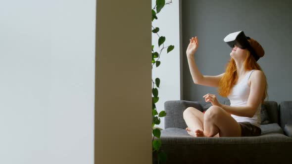 Woman using virtual reality headset in living room 4k