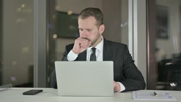 Sick Businessman Having Coughing in Office at Night 