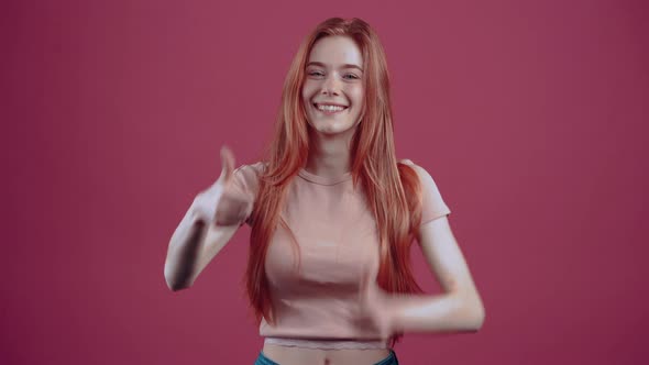 Wide Smile of a Redhead in a Pink Casual Tshirt Isolated on a Pink Background