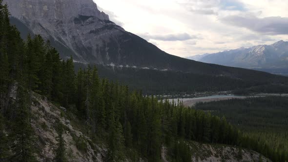 Low and close flight over larch forests of Kananaskis Country revealing beautiful rocky mountains an