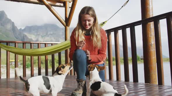 Caucasian couple spending time at home together, playing with dogs
