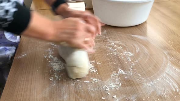 The woman kneads the dough