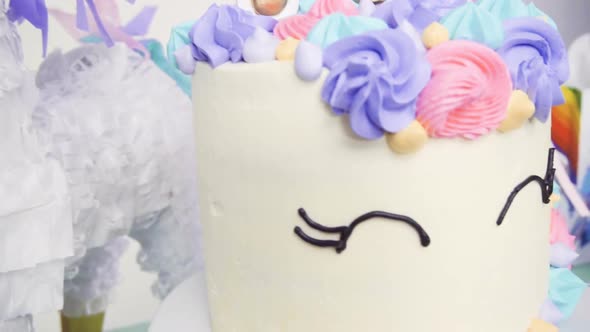 Slow motion. Close up of unicorn cake at little girl birthday party.