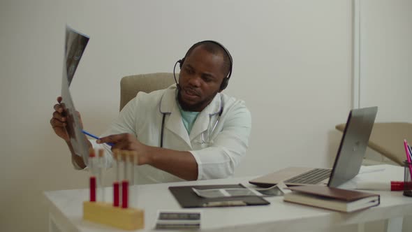 Black Male Doctor Video Conferencing Online Consulting with Colleague About Patient Diagnosis