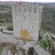 Sortelha medieval castle or Castelo de Sortelha with portuguese flag on top. Aerial drone circling - VideoHive Item for Sale
