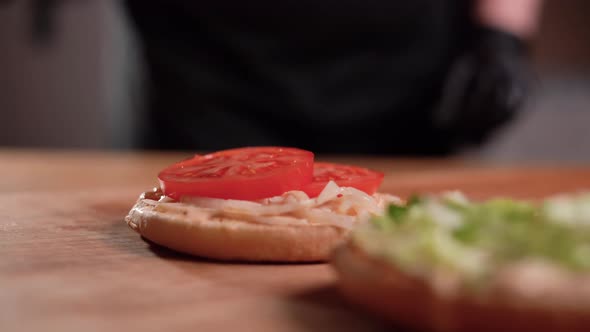 Closeup View of a Professional Chef Preparing Delicious and Juicy Burgers at a Fast Food Restaurant