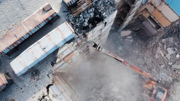 Dismantling of concrete structures with an excavator.