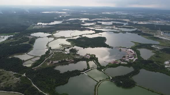 Aerial view reflection at abandoned tin mining lake and plantation