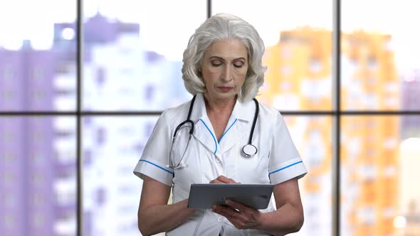 Old Female Doctor Swiping Digital Tablet Pc