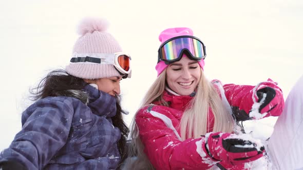 Two Gorgeous Laughing Young Woman at Ski Resort