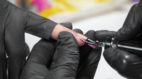 nail builder applying gel polish UHD