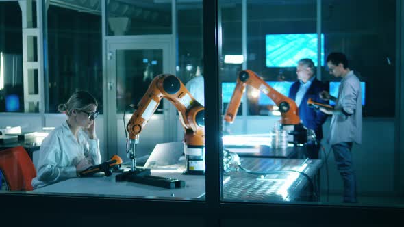 Robotics Laboratory with a Group of Scientists Having a Discussion