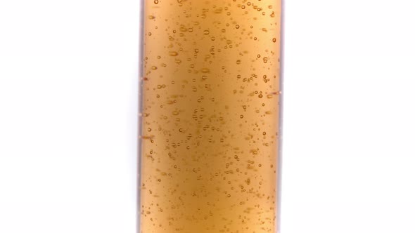 Transparent Gel with Air Bubbles in Glass Bottle Rotating 360 Isolated on White