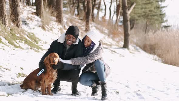 African American Couple on the Walk with Spaniel Dog in Winter