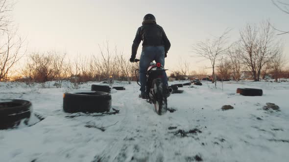 Biker Ride on Bike in the Snow Field Slow Motion