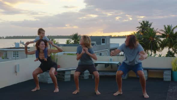 Cinematic Shot of Happy Smiling Family with Children Doing Exercises of Gymnastics Together at