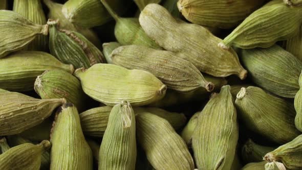  Dried green cardamom pods close up full frame as background