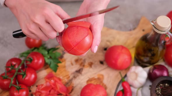 Woman Peels a Tomato Peel By Knife at Domestic Kitchen