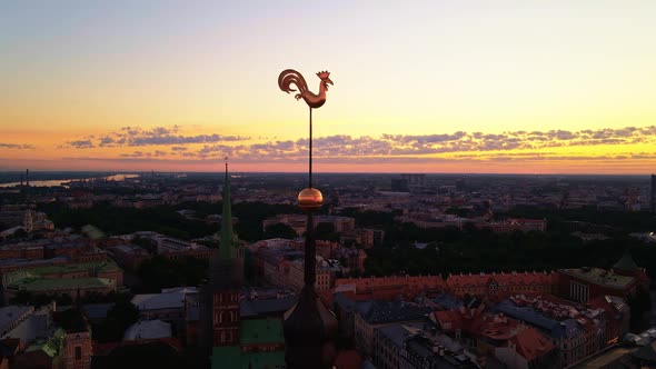 Aerial View of Two Golden Weather Cocks or Roosters of Riga's Old Town During Amazing Scenic Sunrise