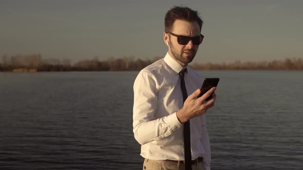 Satisfied Man Taking Selfie On Mobile Phone. Businessman In White Shirt Taking Self Photo.