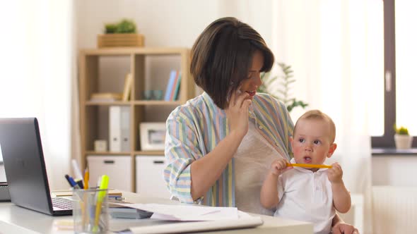 Working Mother with Baby Calling on Smartphone 