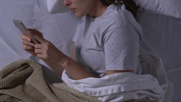 Woman Chatting With Boyfriend on Smartphone, Lying in Bed at Night, Relations