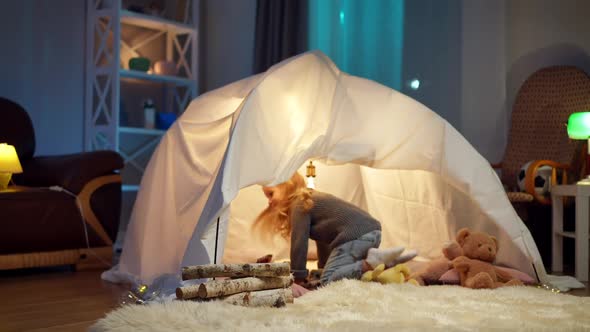 Wide Shot Comfortable Living Room with Cozy Tent and Pretty Little Girl Running Sitting Inside