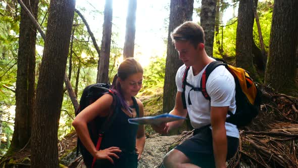 Happy hiker couple looking at map