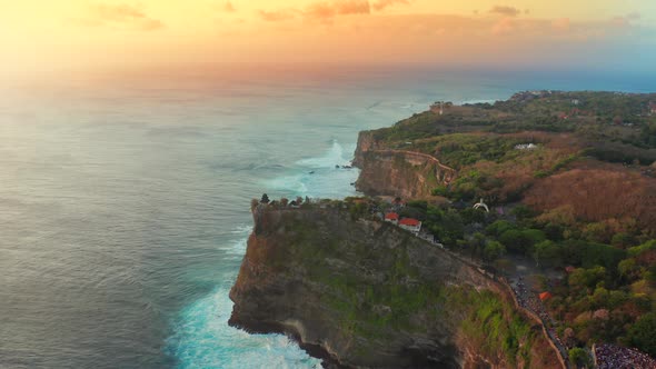 Aerial View on Big Ocean Waves and Rocks at Sunset Time in Uluwatu Temple at the Bali Island
